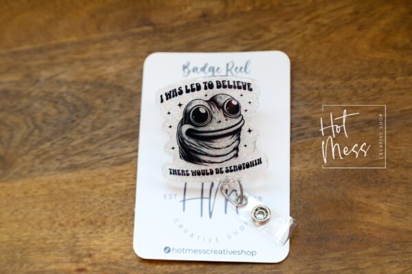 I was told there would be Serotonin Badge Reel, Frog Badge Reel, Retractable Acrylic Badge Reel, Mental Health, Therapist ID Holder