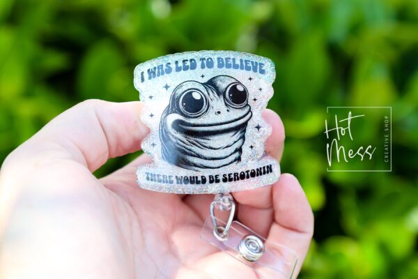 I was told there would be Serotonin Badge Reel, Frog Badge Reel, Retractable Acrylic Badge Reel, Mental Health, Therapist ID Holder
